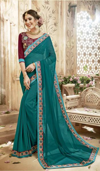 Grab This Lovely Saree In Blue Color Paired With Contrasting Maroon Colored Blouse. This Saree Is Fabricated On Georgette Paired With Art Silk Fabricated Blouse. It Has Embroidery Over The Blouse And Lace Border.