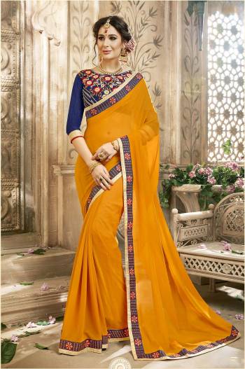 Celebrate This Festive Season Wearing This Saree In Musturd Yellow Color Paired With Contrasting Royal Blue Colored Blouse. This Saree Is Fabricated On Georgette Paired With Art Silk Fabricated Blouse. Buy This Saree Now.