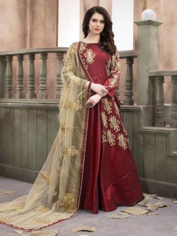 Adorn The Angelic Look Wearing This Designer Floor Length Suit In Red Color Paired With Red Colored Bottom And Beige Colored Dupatta. Its Top Is Fabricated On Art Silk Paired With Santoon Bottom And Net Dupatta. Its Rich Combination And Embroidery Will Earn You Lots Of Compliments From Onlookers. Buy Now.