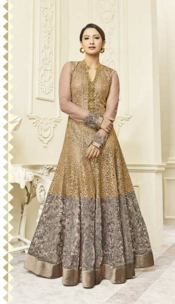 Flaunt Your Rich And Elegant Taste Wearing Heavy Designer Floor Length Suit In Beige Color Paired With Beige Colored Bottom And Dupatta. Its Top Is Fabriacted On Net Paired With Santoon Bottom And Chiffon Dupatta. It Has Heavy Embroidery All Over It. Buy Now.