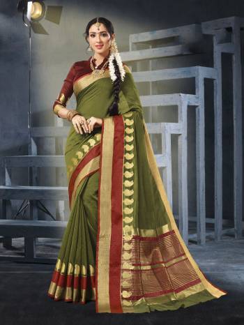 Add This New Shade To Your Wardrobe With This Saree In Olive Green Color Paired With Contrasting Maroon Colored Blouse. This Saree And Blouse Are Fabricated On Cotton Silk Which Is Easy To Drape And Carry All Day Long. Buy Now.