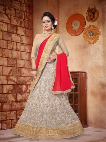 Simple And Elegant Looking Designer Lehenga Choli Is Here In Beige Color Paired With Contrasting Red Colored Dupatta. Its Blouse Is Fabicated On Art Silk Paired With Georgette Fabricated Lehenga And Dupatta. It Has Heavy Attractive Embroidery All Over It.