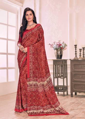 Adorn The Angelic Look Wearing This Saree In Red Color Paired With Red Colored Blouse. This Saree And Blouse Are Fabricated On Crepe Beautified With Prints All Over.