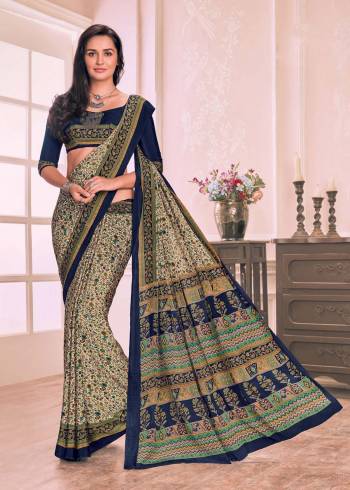 Flaunt Your Rich And Elegant Taste Wearing This Saree In Cream Color Paired With Contrasting Navy Blue Colored Blouse. This Saree And Blouse Are Fabricated On Crepe Beautified With Small Floral Prints.