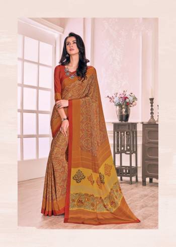 Simple Saree Is Here In Musturd Yellow Color Paired With Contrasting Rust Orange Colored Blouse. This Saree And Blouse Are Fabricated On Crepe Beautified With Smal Floral Prints.