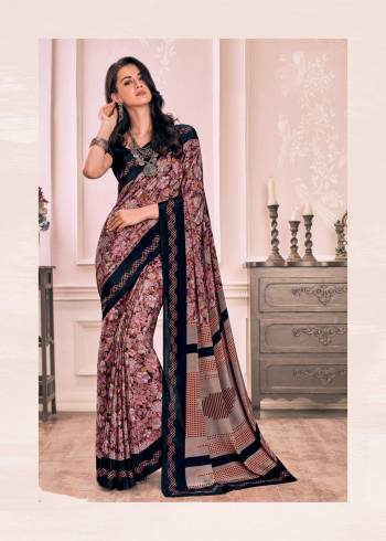 Here Is Saree Perfect For Your Casual Or Semi-Casual Wear, Grab This Saree In Pink Color Paired With Contrasting Dark Blue Colored Blouse. This Saree And Blouse Are Fabricated On Crepe Beautified With  Prints All Over It. Buy Now.