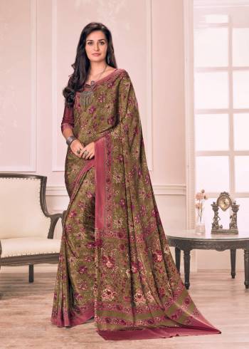 New And Unique Shade Is Here With This Saree In Olive Green Color Paired With Contrasting Wine Colored Blouse. This Saree And Blouse Are Fabricated On Crepe Beautified With Floral Prints All Over It.