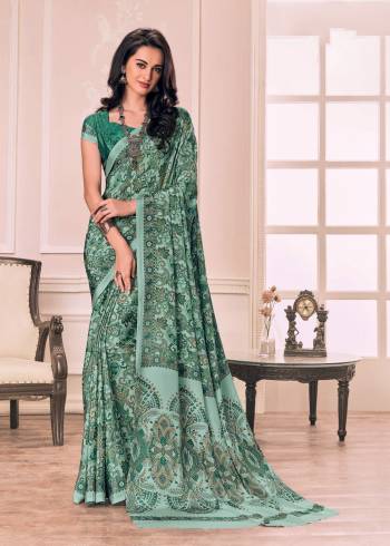 Add This Pretty Saree To Your Wardribe In Light Green color Paired With Green Colored Blouse. This Saree And Blouse Are Fabricated On Crepe Beautified With Prints All Over.