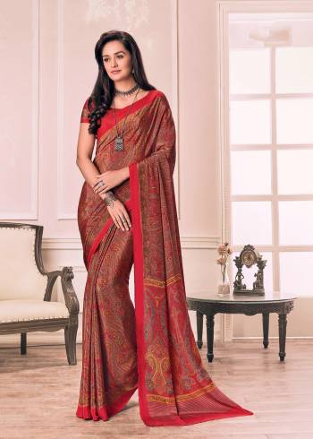 Adorn The Angelic Look Wearing This Saree In Red Color Paired With Red Colored Blouse. This Saree And Blouse Are Fabricated On Crepe Beautified With Prints All Over.