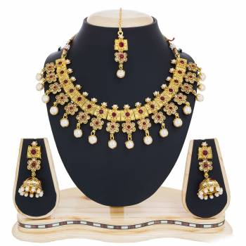 Simple And Elegant Necklace Set Is Here In Golden Color Beautified With White Colored Stones And Pearl. This Necklace Set Is Light Weight And Can Be Paired With Any Attire Like Kurti, Suit, Saree Or Lehenga. Buy Now.