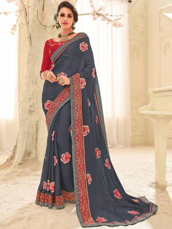 Classy, sensuous and versatile are the perfect words to describe this grey color bright Chiffon saree. Ideal for party, festive & social gatherings. this gorgeous saree featuring a beautiful mix of designs. Its attractive color and designer patch, stone, floral design work over the attire & contrast hemline adds to the look. Comes along with a contrast unstitched blouse.