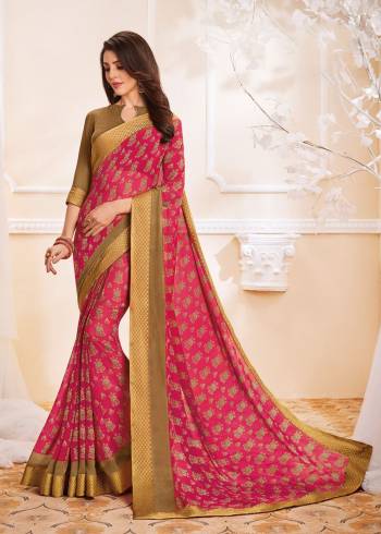 You Will Definitely Earn Lots Of Compliments Wearing This Saree In Dark Pink Color Paired With Light Brown Colored Blouse. This Saree And Blouse Are Fabricated On Goergette With Simple Prints All Over And Lace Border.