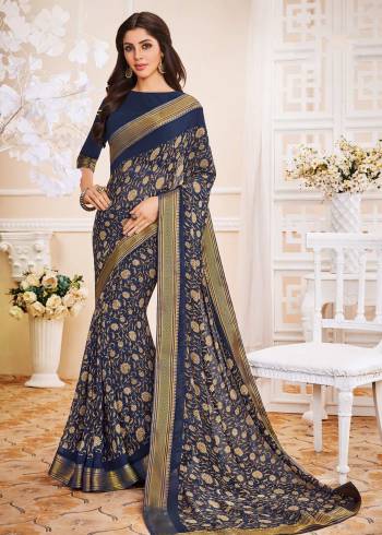 Enhance Your Personality Wearing This Saree In Navy Blue Color Paired With Navy Blue Colored Blouse. This Saree And Blouse Are Fabricated On Georgette Beautified With Prints All Over. Buy This Elegant Looking Saree Now.