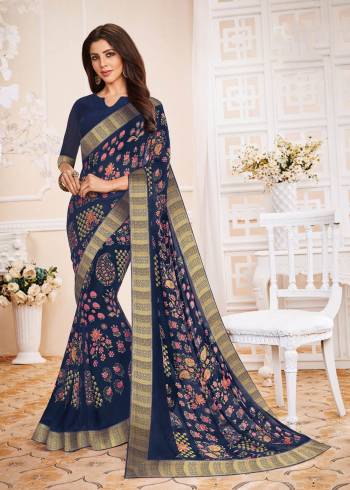 Enhance Your Personality Wearing This Saree In Navy Blue Color Paired With Navy Blue Colored Blouse. This Saree And Blouse Are Fabricated On Georgette Beautified With Prints All Over. Buy This Elegant Looking Saree Now.