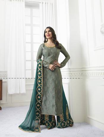 Earn Lots Of Compliments Wearing This Designer Suit In Grey Colored Straight Top Paired With Contrasting Teal Blue Colored Plazzo And Dupatta. Its Top Is Fabricated On Satin Paired With Embroidered Santoon Plazzo And Embroidered Chiffon Dupatta. This Designer Suit Is Comfortable To Carry Throughout The Gala.