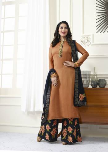 New And Unique Shade IS Here With This Designer Suit In Rust Orange Colored Top Paired With Black Colored Embroidered Plazzo And Dupatta. Its Top Is Fabricated On Satin Paired With Santoon Bottom And Chiffon Dupatta. Its Pretty Unique Color And Floral Embroidery Is Making The Suit Very Attractive.