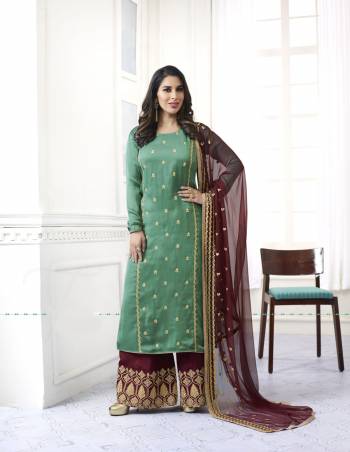 Get Ready For The Coming Festive Season With This Plazzo Suit In Green Colored Top Paired With Contrasting Maroon Colored Bottom And Dupatta. Its Top Is Fabricated On Satin Paired With Santoon Bottom And Chiffon Dupatta. It Is Light Weight And Easy To Carry All Day Long.