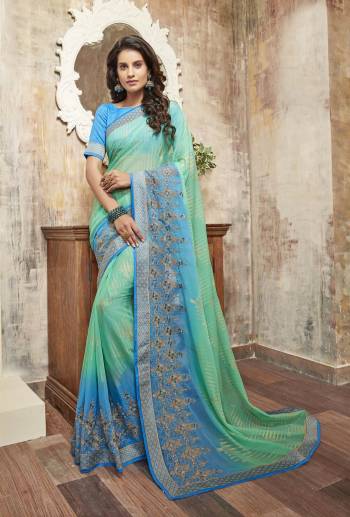 Here Is A Saree In Selected Cool Color Pallete. This Saree Is In Sea Green and Blue Color Paired With Turquoise Blue Colored Blouse. This Saree Is Fabricated On Chiffon Paired With Art Silk Fabricated Blouse. It Has Prints All Over And Beautified With Embroidery Over The Saree Border.