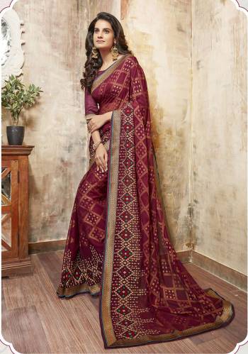 Grab This Lovely Saree For The Next Function You Attend With This Saree In Wine Color Paired With Wine Colored Blouse. This Saree Is Fabricated On Chiffon Paired With Art Silk Fabricated Blouse. It Has Prints All Over With Embroidery Over The Saree Border.