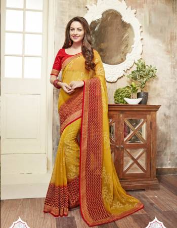 Adorn The Traditional Look Wearing This Saree In Traditonal Combination With Saree In Yellow Color Paired With Contrasting Red Colored Blouse. This Saree Is fabricated On Chiffon Paired With Art Silk Fabricated Blouse. It Has Embroidery Over The Broad Lace Border.