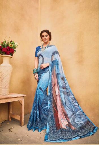 Shades Are In This Season So Grab This Saree In Shaded Blue Color Paired With Blue Colored Blouse. This Saree Is Fabricated On Georgette  Paired With Art Silk Fabricated Blouse. It Is Beautified with Abstract Prints Which Will Earn You Lots Of Compliments From Onlookers.