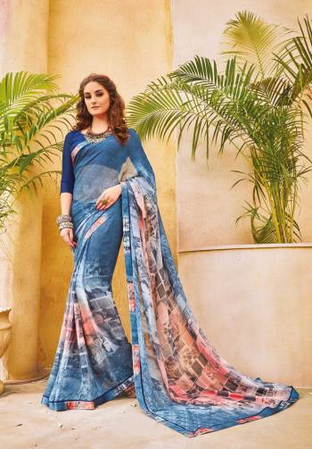 Shades Are In This Season So Grab This Saree In Shaded Blue Color Paired With Dark Blue Colored Blouse. This Saree Is Fabricated On Georgette  Paired With Art Silk Fabricated Blouse. It Is Beautified with Abstract Prints Which Will Earn You Lots Of Compliments From Onlookers.