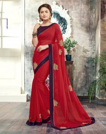 Adorn The Angelic Look, Wearing This Vibrant Saree In Red Color Paired With Contrasting Violet Colored Blouse. This Saree Is Fabricated On Chiffon Paired With Art Silk Fabricated Blouse. It Has Embroidered Patch Work Over The Saree. Buy Now.