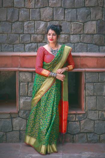 Here Is A Proper Traditonal Colored Saree In Green Color Paired With Contrasting Red Colored Blouse. This Saree And Blouse Are Fabricated On Jacquard Silk Beautifid With Weave. Buy this Saree Now.