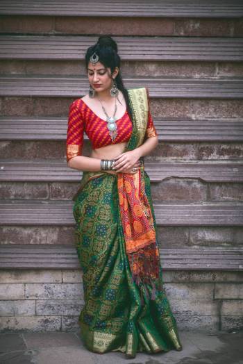 Celebratr this Festive Seaosn Wearing This Saree In Dark Green Color Paired With Contrasting Red Colored Blouse. This Saree And Blouse Are Fabricated On Jacquard Silk Beautified With Weave All Over It. Its Color Combination Will Make you Look The Most Attractive Of All.