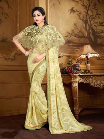 Simple And Elegant Looking Saree Is Here In Cream Color Paired With Dark Green Colored Blouse Cream Colored Cape. This Saree Is Fabricated On Georgette Brasso Paired With Crepe Fabricated Blouse And Net Cape. This Saree Ensures Superb Comfort All Day Long. 