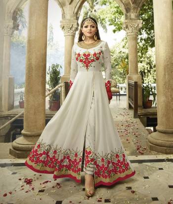 Adorn The Angelic Look Wearing This Designer Floor Length Suit In White Color Paired With Embroidered White Colored Bottom And Red Colored Dupatta. Its Top Is Fabricated On Georgette Paired With Santoon Bottom And Chiffon Dupatta. This Suit Looks More Attractive As It Is Beautified with Red Colored Embroidery. Buy now.