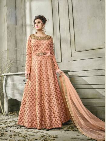 Grab This Cold Shoulder Patterned Readymade Designer Floor Length suit In Peach Colored Top Paired With Peach Colored Bottom And Dupatta. Its Top Is Fabricated On Satin Silk Paired With Santoon Bottom And Net Dupatta. It Has Heavy Embroidered Neckline And Small Motifs All Over The Top.