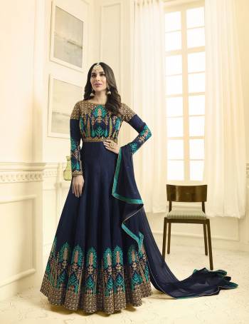 For A Great And Attractive Personality, Grab This Designer Floor Length Suit In Navy Blue Color Paired With Navy Blue Colored Bottom And Dupatta. Its Top Is Fabricated On Art Silk Paired With Santoon Bottom And Chiffon Dupatta. It Has Embroidery Over The Yoke And Panel Of The Suit. Buy Now.