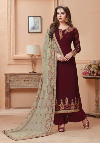 Royal Looking Designer Straight Cut Suit IS Here In Maroon Colored Top And Bottom Paired With Contrasting Grey Colored Dupatta. Its Top Is Fabricated On Georgette Paired With Santoon Bottom And Chiffon Dupatta. This Rich Looking Combination Will Earn Your Lots Of Compliments From Onlookers.