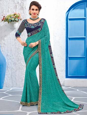 Impress everyone with your amazing Trendy look by draping this Turquoise Blue color Georgette saree. this party wear saree won't fail to impress everyone around you. this gorgeous saree featuring a beautiful mix of designs. Its attractive color and designer embroidered design, stone, designer heavy blouse and beautiful floral design work over the attire & contrast hemline adds to the look. Comes along with a contrast unstitched blouse.