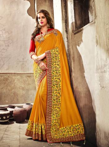 Celebrate This Festive Season Wearing This Saree In Musturd Yellow Color Paired With Contrasting Red Colored Blouse. This Saree Is Fabricated On Satin Silk Paired With Art Silk Fabricated Blouse. It Has Heavy Embroidered Lace Border Making The Saree Attractive.