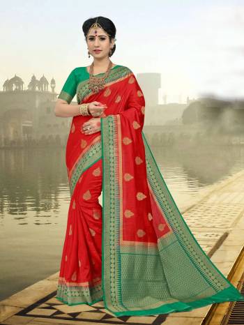 Here Is A Proper Traditional Looking Saree In Red Color Paired with Contrasting Green Colored Blouse. This Saree And Blouse Are Fabricated On Art Silk Beautified With Weave All Over It. Buy Now.