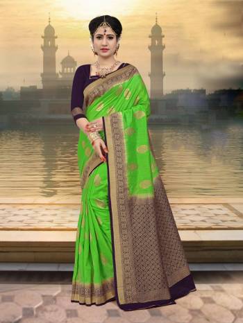 Add This Lovely Saree To Your Wardrobe In Green Color Paired With Contrasting Purple Colored Blouse. This Saree And Blouse Are Fabricated On Art Silk Beautified With Weave. 