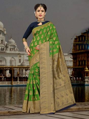 Add This Lovely Saree To Your Wardrobe In Green Color Paired With Contrasting Steel Blue Colored Blouse. This Saree And Blouse Are Fabricated On Art Silk Beautified With Weave. 