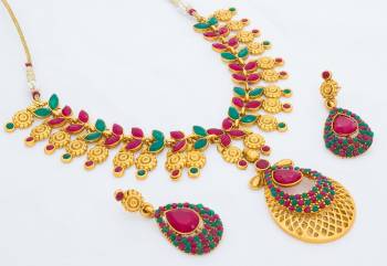 Here Is A Beautiful And Heavy Necklace Set In Golden Color Beautified With Pink And Green Colored Heavy Stone Work. This Necklace Can Be Paired With Saree Or Lehenga Choli. Buy Now.