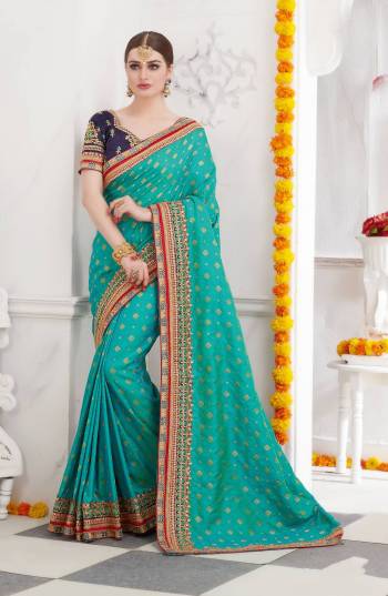 Go With Some Cool Pallete With This Designer Saree In Turquoise Blue Color Paired With Navy Blue Colored Blouse. This Saree Is Fabricated On Satin Silk Paired With Art Silk Fabricated Blouse. This Saree Is Beautified With Heavy Embroidery Over the Saree And Blouse. Buy Now.