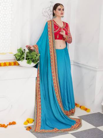 Look Colorful And Attractive Wearing This Designer Saree In Blue Color Paired With Contrasting Red Colored Blouse. This Saree Is Fabricated On Satin Silk Paired With Art Silk Fabricated Blouse. Its Designer Blouse And Saree Lace Border Is Making The Saree Look Attractive.