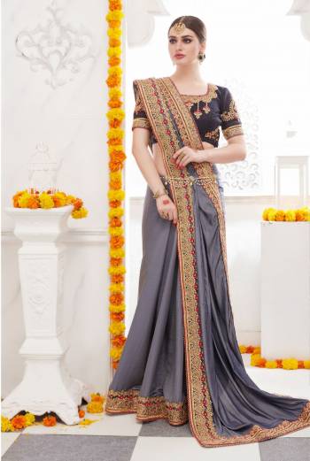 Flaunt Your Rich And Elegant Taste Wearing This Designer Saree In Grey Color Paired With Black Colored Blouse. This Saree Is Fabricated On Satin Silk Paired With Art Silk Fabricated Blouse. It Has Attractive Embroidery Over the Blouse And Lace Border. Buy It Soon Before The Stock Ends.