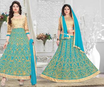 Attractive Color Is Here Which Make You Earn Lots Of Compliments From Onlookers. This Suit Has A Beige Colored Blouse And Bottom With Turquoise Blue Colored Lehenga And Dupatta. Get This Stitched As A Lehenga Choli Or An Anarkali Suit. Its Blouse Is Fabricated On Art Silk Paired With Net Fabricated Lehenga, Santoon Bottom And Chiffon Dupatta. 