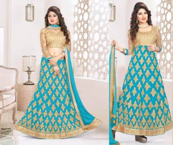 Attractive Color Is Here Which Make You Earn Lots Of Compliments From Onlookers. This Suit Has A Beige Colored Blouse And Bottom With Turquoise Blue Colored Lehenga And Dupatta. Get This Stitched As A Lehenga Choli Or An Anarkali Suit. Its Blouse Is Fabricated On Art Silk Paired With Net Fabricated Lehenga, Santoon Bottom And Chiffon Dupatta. 