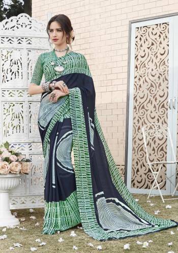 Be It A Casual Or Semi-Casual Wear, Grab This Pretty Saree In Navy Blue And Green Color Paired With Green Colored Blouse. This Saree And Blouse Are Fabricated On Georgette Beautified With Simple Prints. Buy Now.