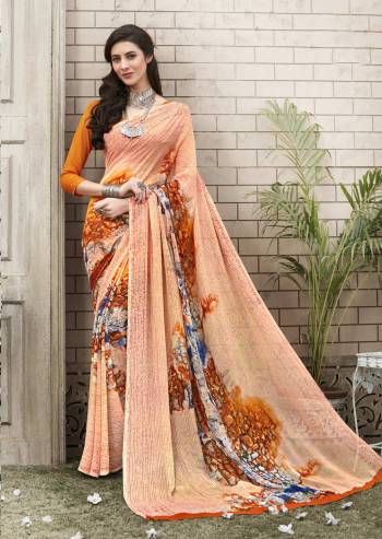 A Must Have Color In Every Women's Wardrobe Is Here With This Saree In Peach Color Paired With Orange Colored Blouse. This Saree And Blouse Are Fabricated On Georgette Beautified With Bold Floral Prints. Buy This Saree Now.