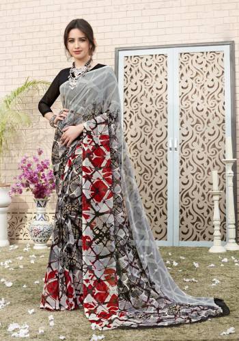 Grab Thuis Saree In Grey Color Paired With Black Colored Blouse. This Saree And Blouse Are Fabricated On Georgette Beautified With Prints All Over It. This Saree Is Light Weight, Easy to Drape And Carry All Day Long.