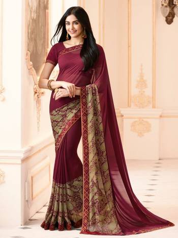 Add This New Color To Your Wardrobe With This Simple And Elegant Saree In Wine Color Paired With Wine Colored Blouse. This Saree And Blouse Are Fabricated On Georgette Paired With Art Silk Fabricated Blouse. Its Has Prints Over The Broad Border. Buy Now.