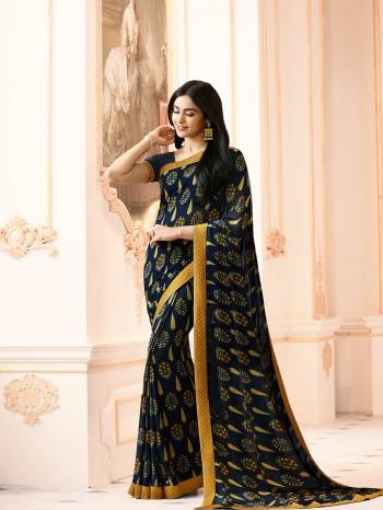 Give Your Perosnality A Very Elegant Look Wearing This Saree In Navy Blue Color Paired With Navy Blue Colored Blouse. This Saree Is Fabricated On Georgette Paired With Art Silk Fabricated Blouse. It Is Beautified With Motif Prints All Over The Saree. This Saree Is Light Weight And Easy To Carry All Day Long.